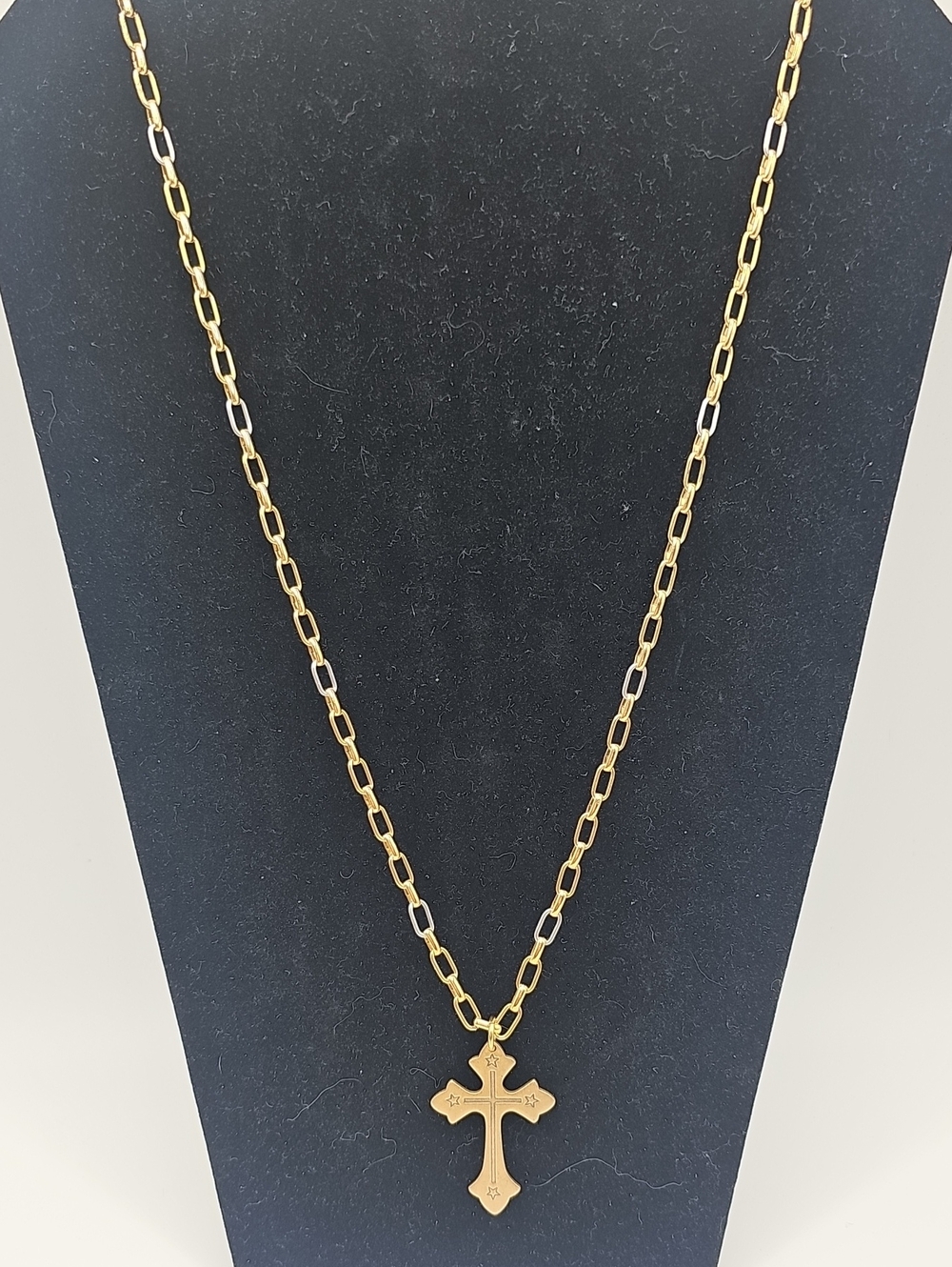 This is a gold-toned cross pendant necklace featuring small engraved star detail